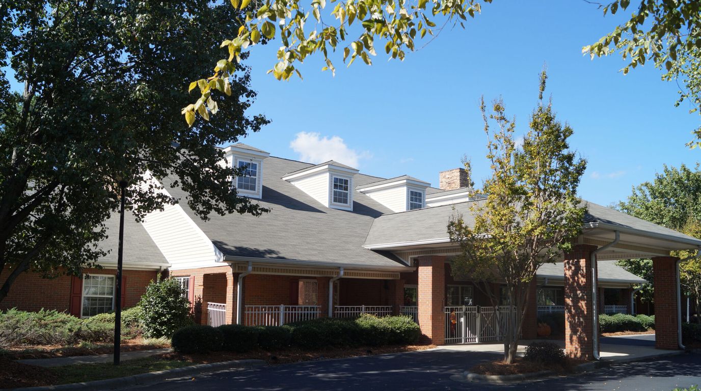 Exterior view of a senior living facility with trees