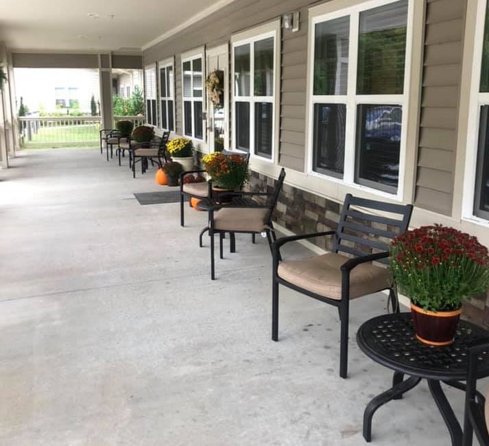 Bryson Senior Living, assisted living in Bryson City, NC — Chairs and potted plants along a covered walkway