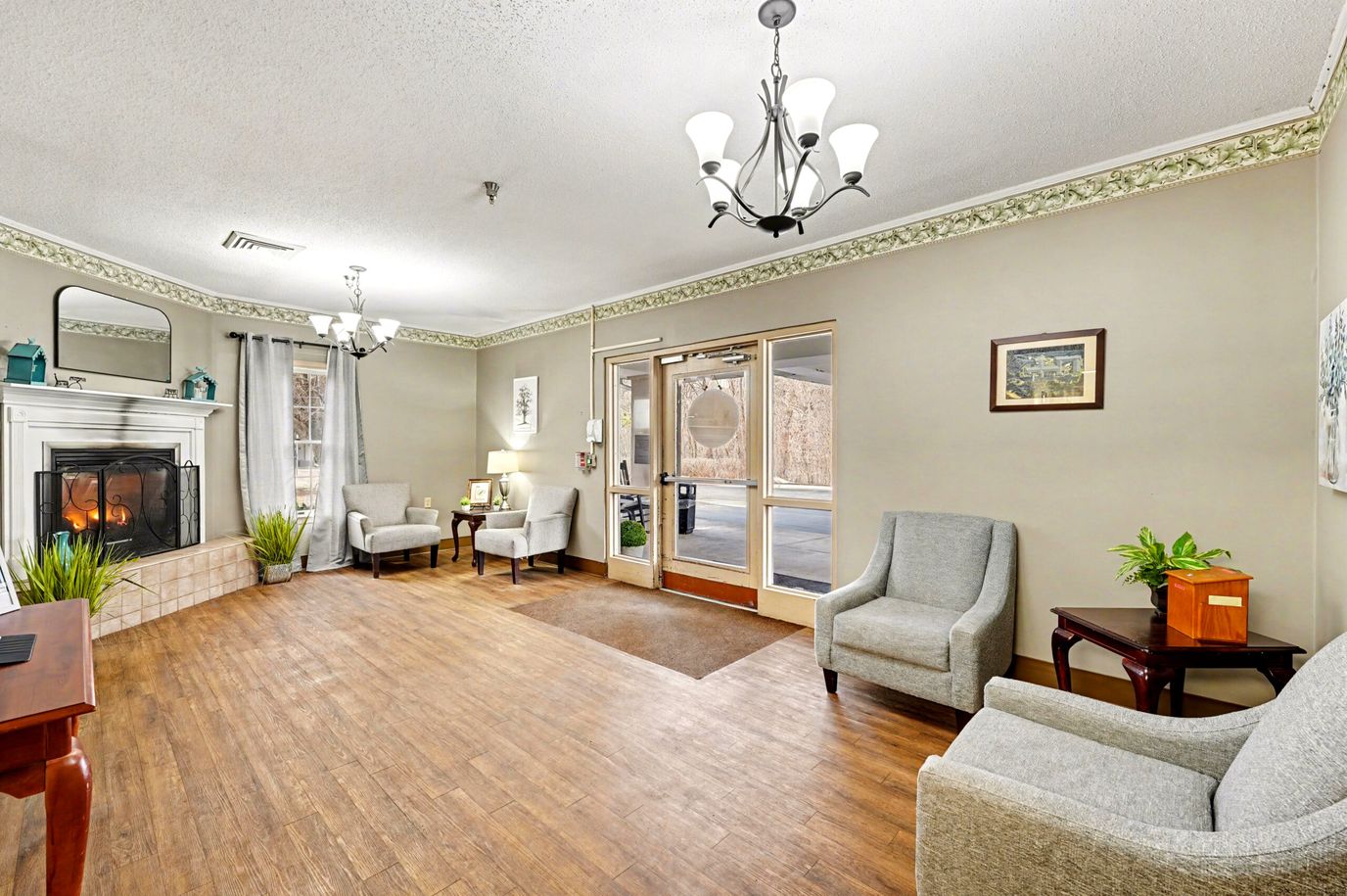 Bright lobby area with chairs and a fireplace