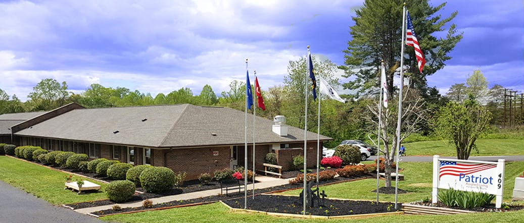 Exterior view of Patriot Living of Yadkinville with flags