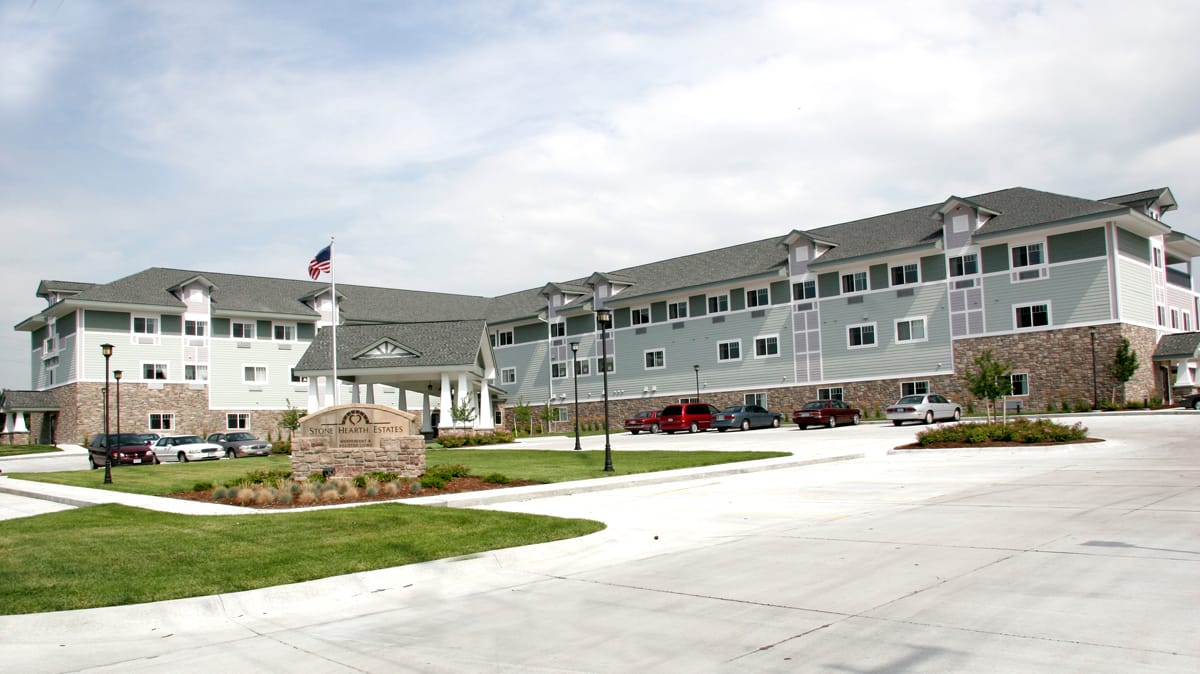 Exterior view of Stone Hearth Estates with landscaped entrance