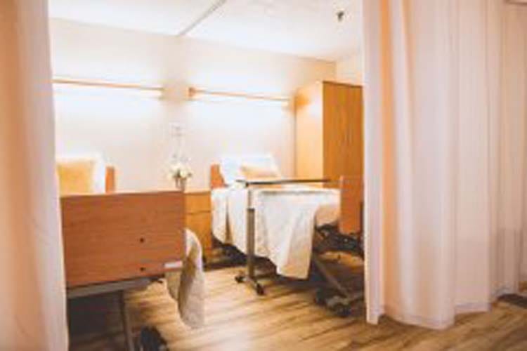 Residents' room with beds and curtains