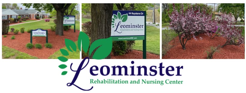 Facility's outdoor signage with flowers and landscaping.