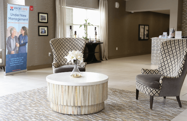 A cozy common area with chairs and a coffee table