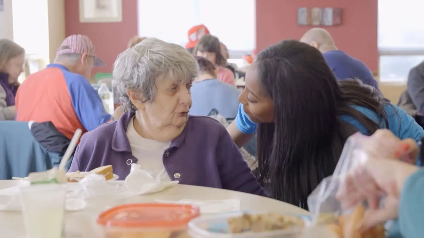 Staff member interacting with a resident during mealtime