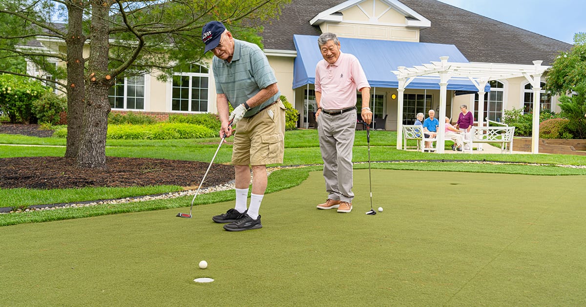 Residents enjoying putting on the outdoor green space