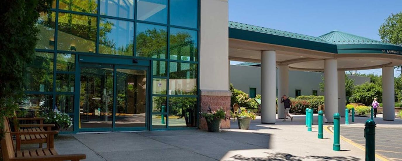 Entrance of Lawrence Rehabilitation Hospital with greenery and benches