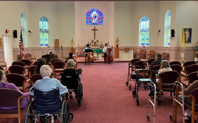 Residents enjoying a musical performance in a chapel