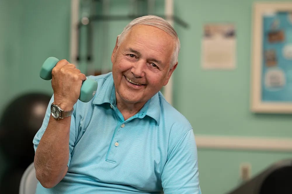 Senior man exercising with a dumbbell in a fitness area