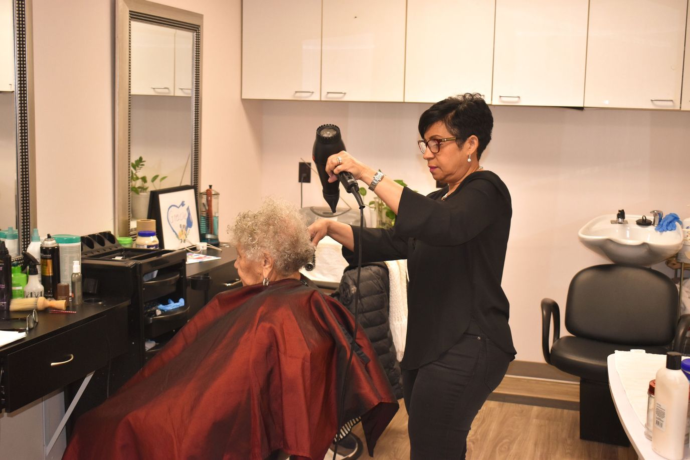Stylist working with a resident in the salon