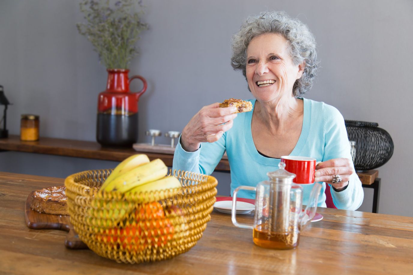 Senior woman enjoying breakfast with a smile