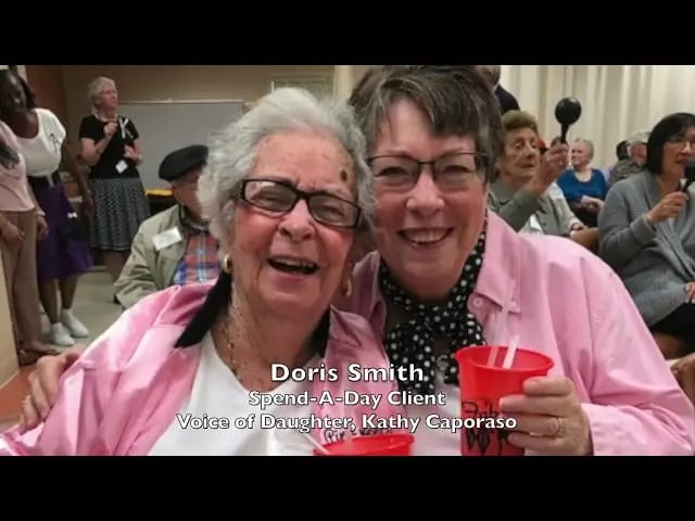 Two smiling residents enjoying an event together
