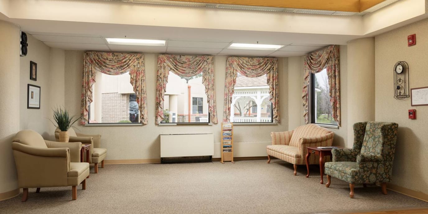 Bright common area with seating and large windows