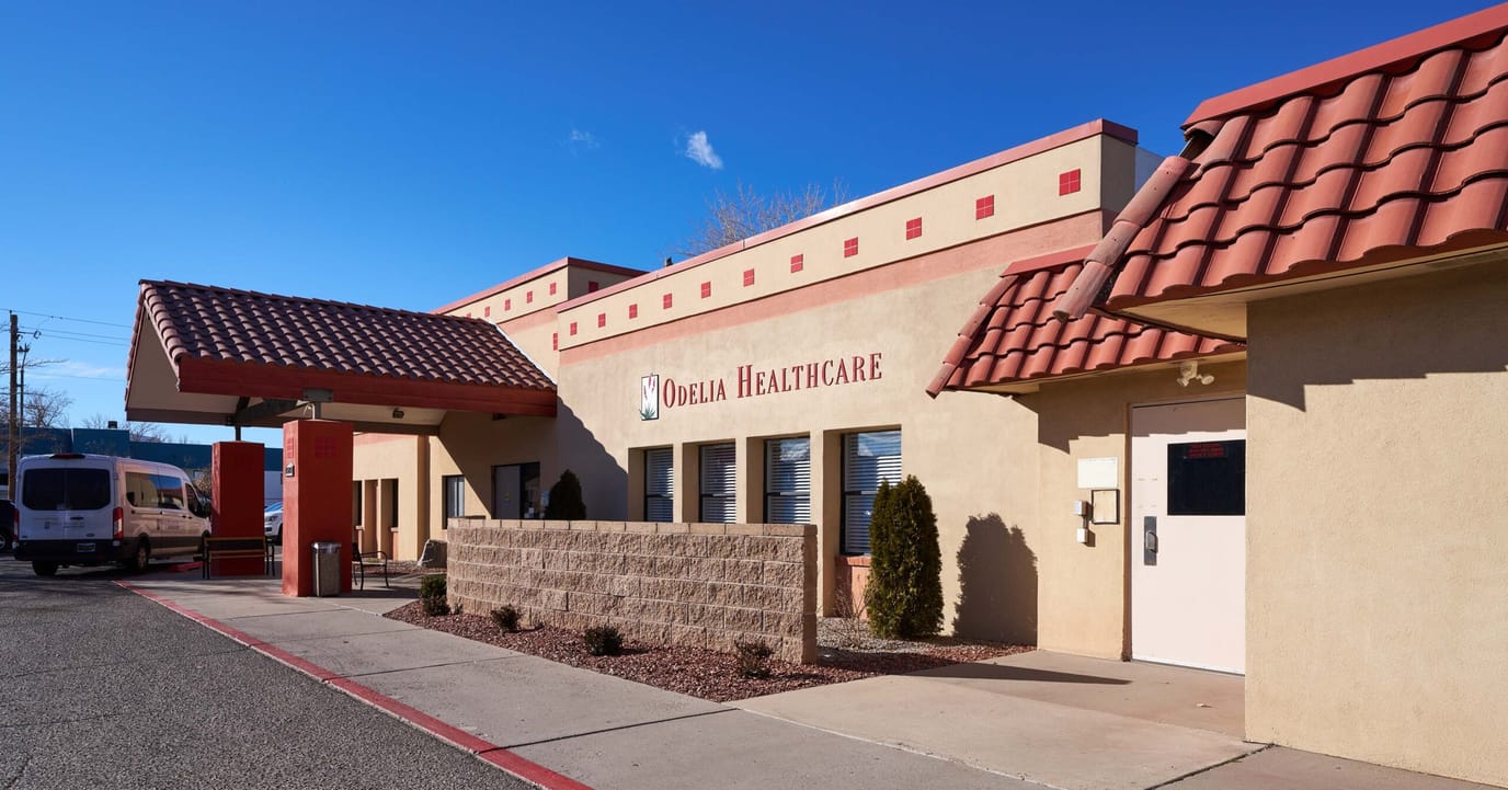 Exterior view of a healthcare facility with a van