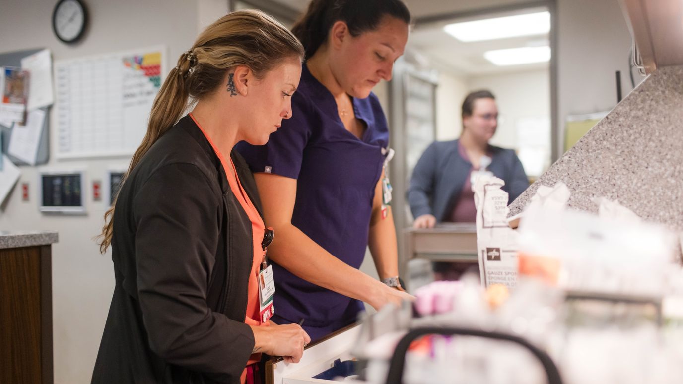 Two female staff members working in a facility interior