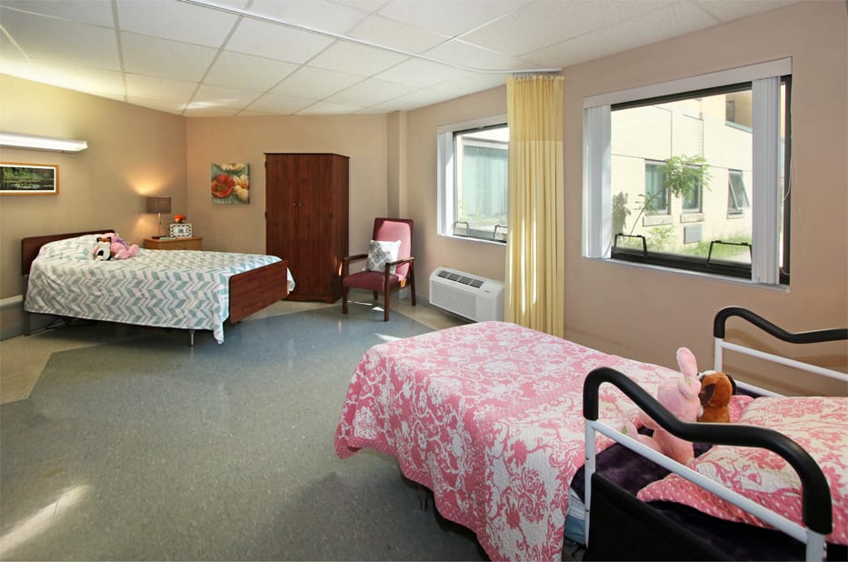 A cozy shared resident room with two beds