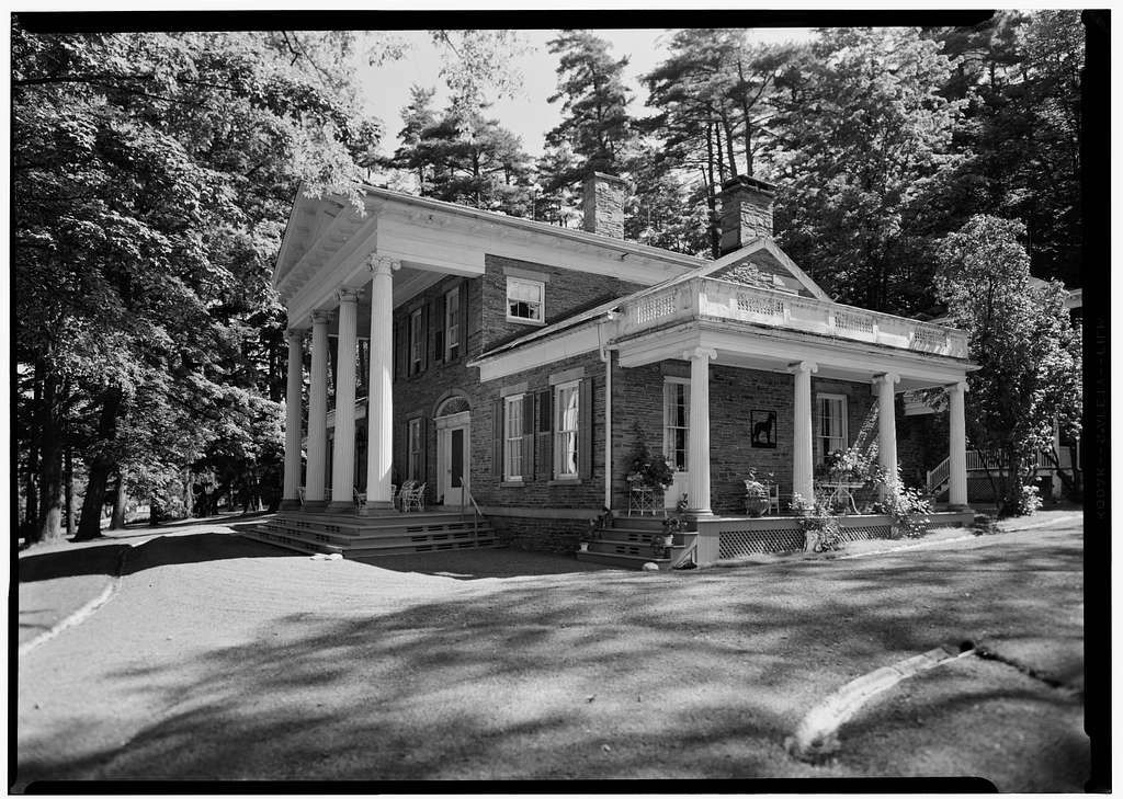 Exterior view of a large historic building surrounded by trees