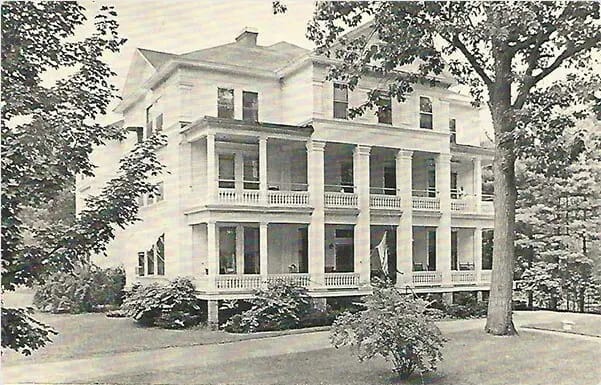 Historic building exterior with columns and greenery