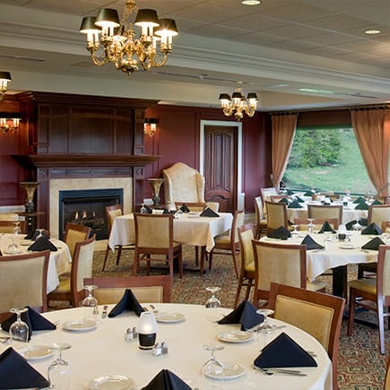 Elegant dining room setup with tables and chandeliers