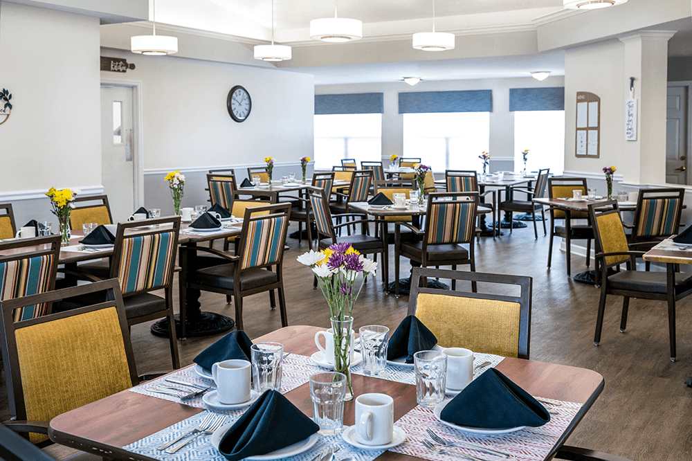 Dining room setup with flowers and table settings
