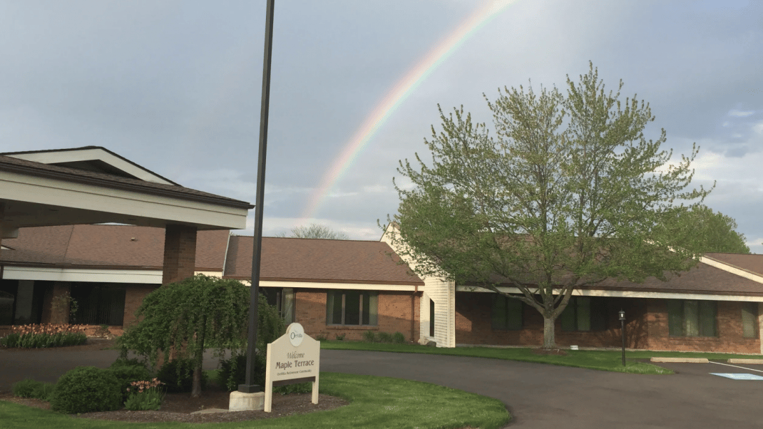 Exterior view of Maple Terrace with a rainbow