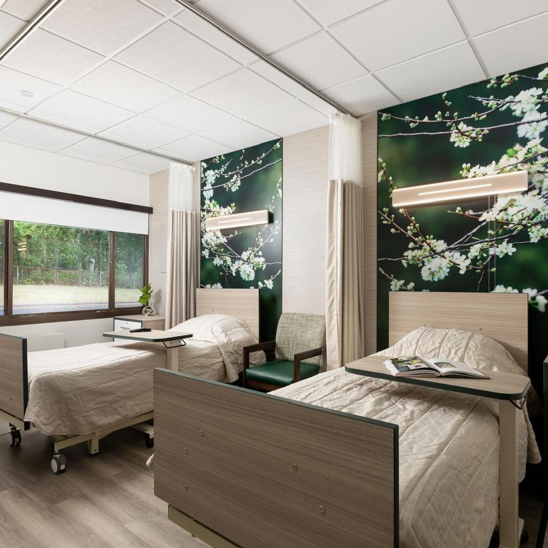 A well-furnished resident room with two beds