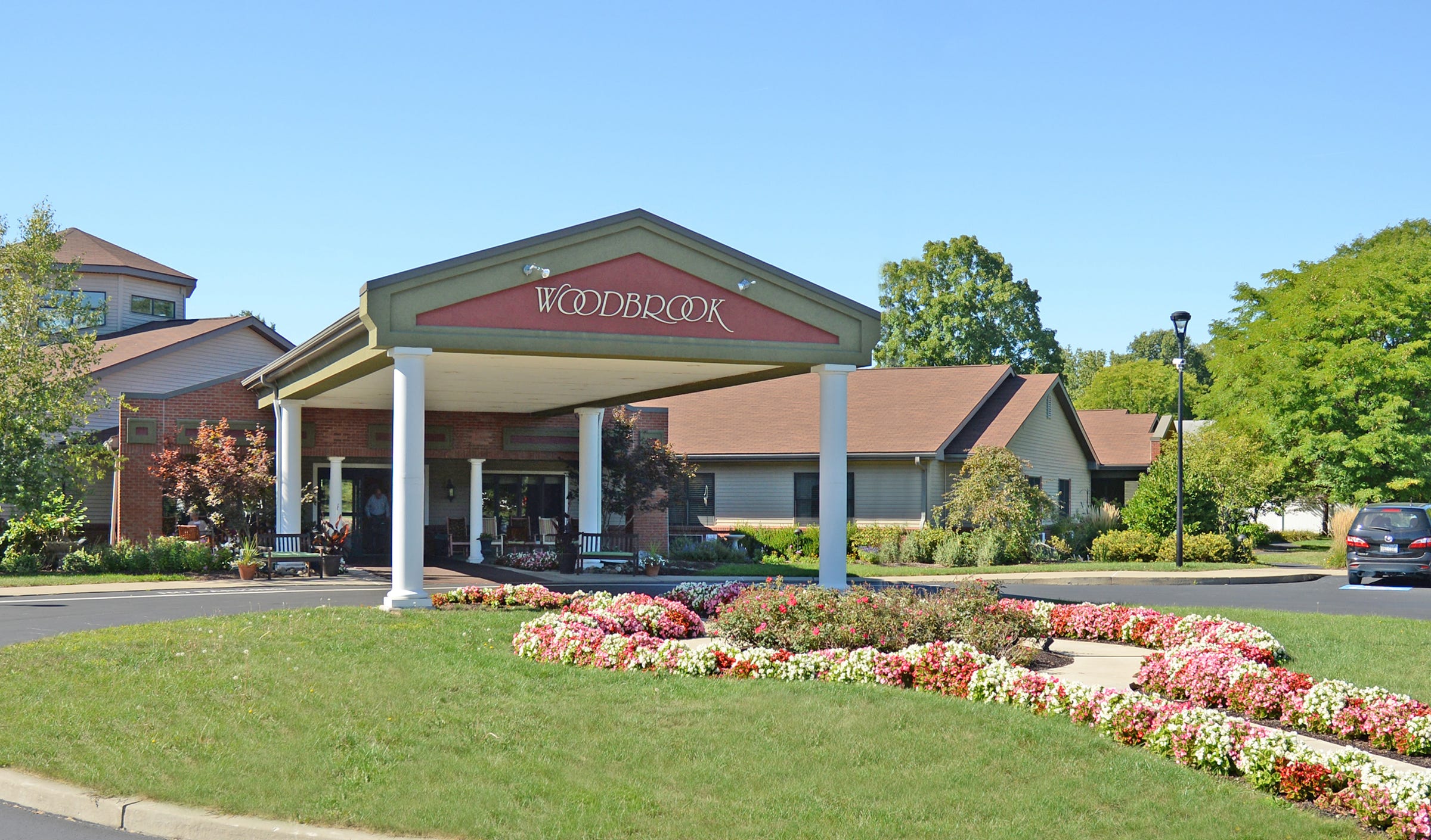 Exterior view of Woodbrook facility entrance with flowers