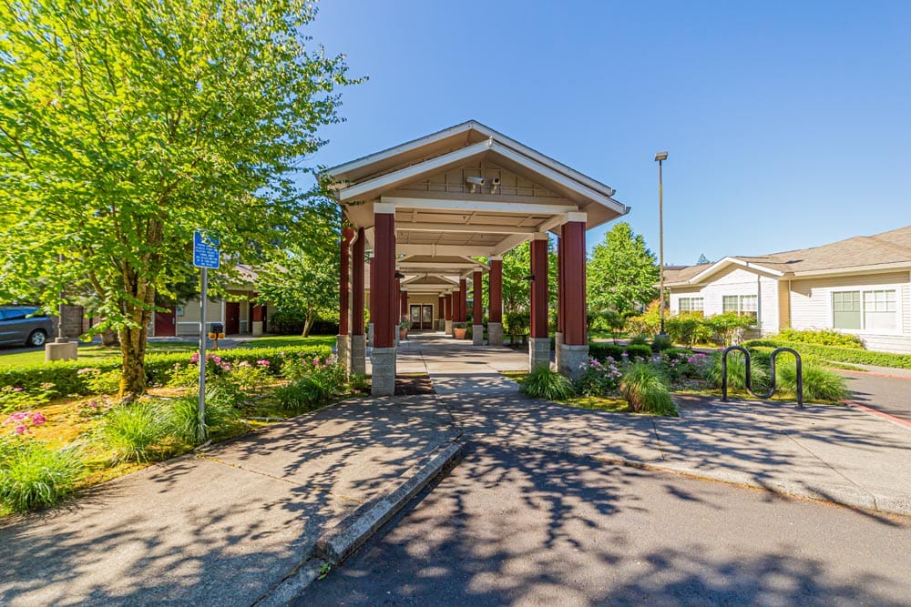 Entrance of Avalon Care Center with landscaped gardens