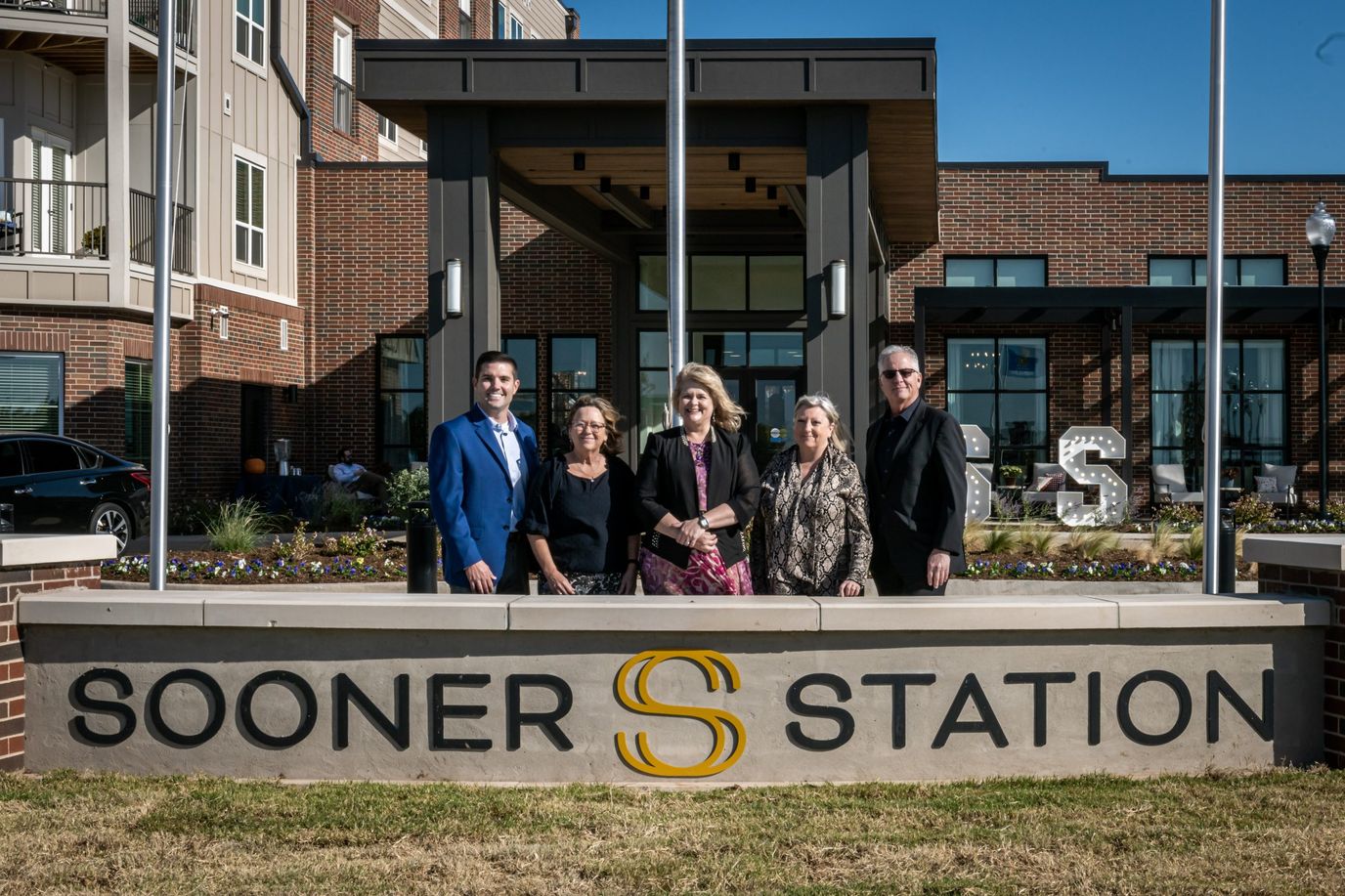 Group of people in front of Sooner Station building