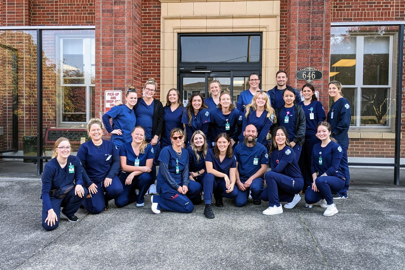 Staff members posed outside the facility entrance