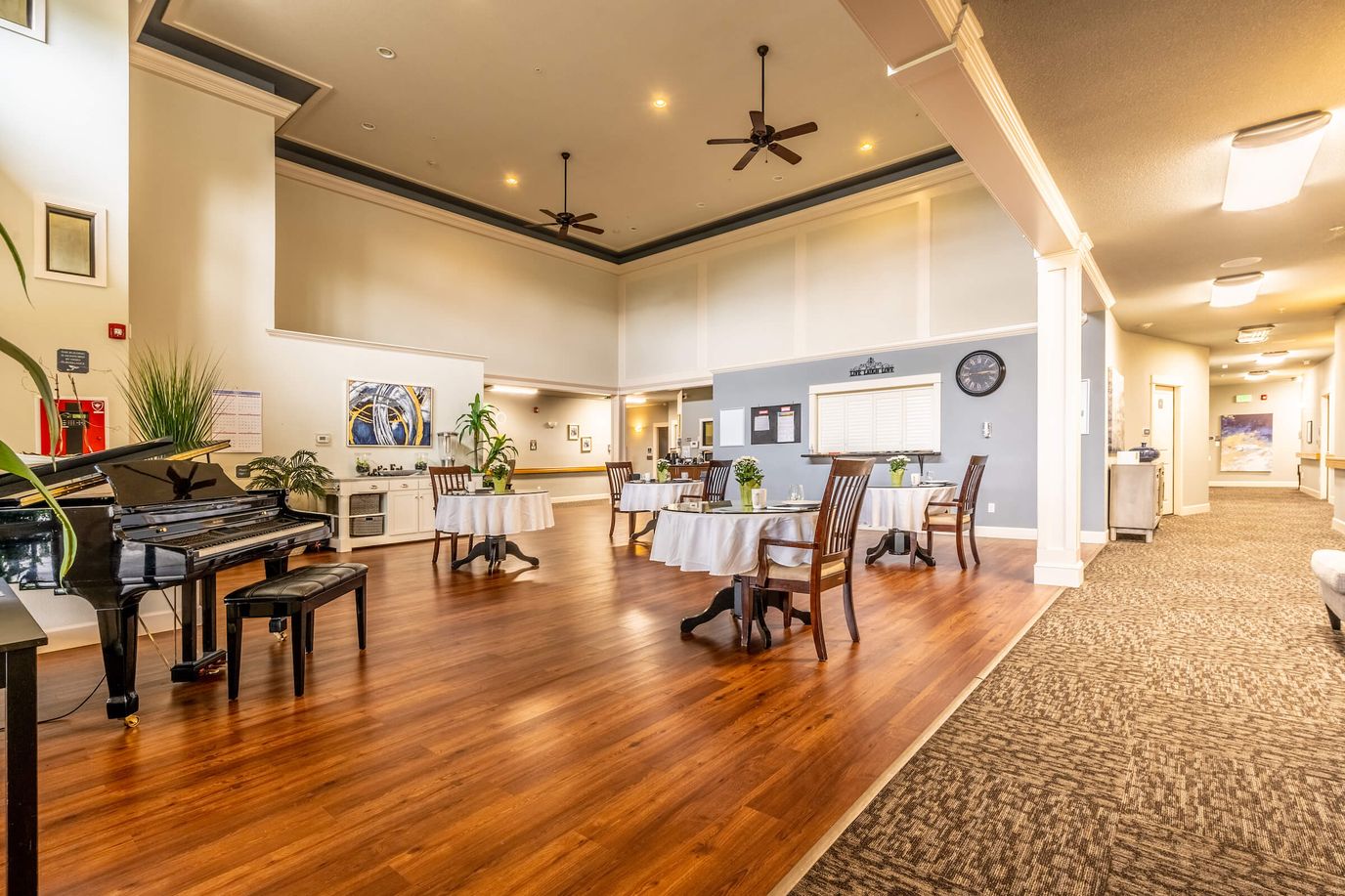 Bright common area with seating and piano
