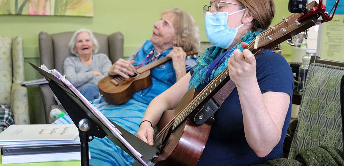 Residents enjoying a music session in a common area
