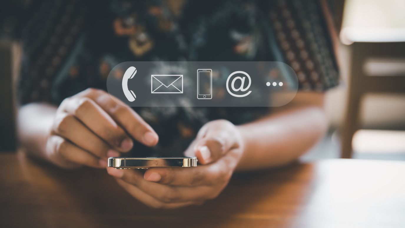 Person using a phone with contact icons overlay