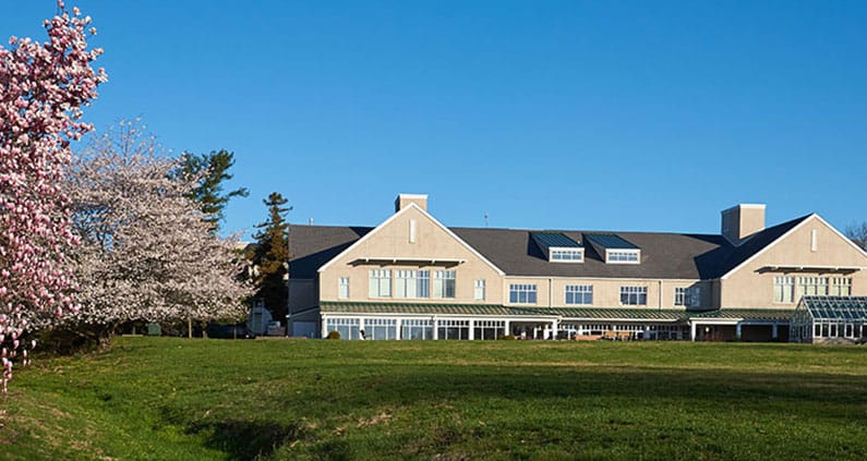 Exterior view of Foulkeways at Gwynedd with blooming trees