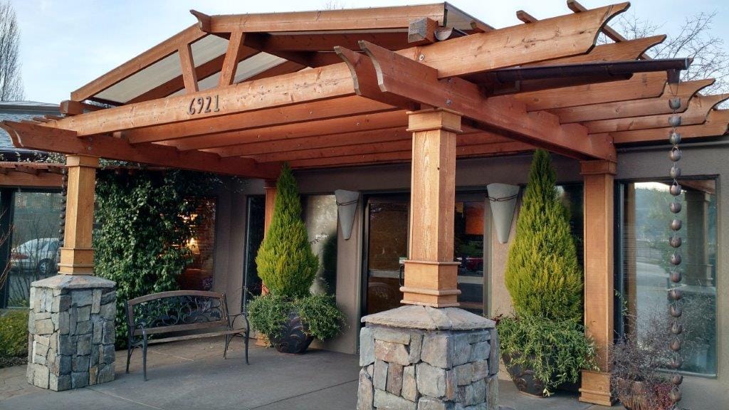 Exterior view of the facility entrance with wooden pergola