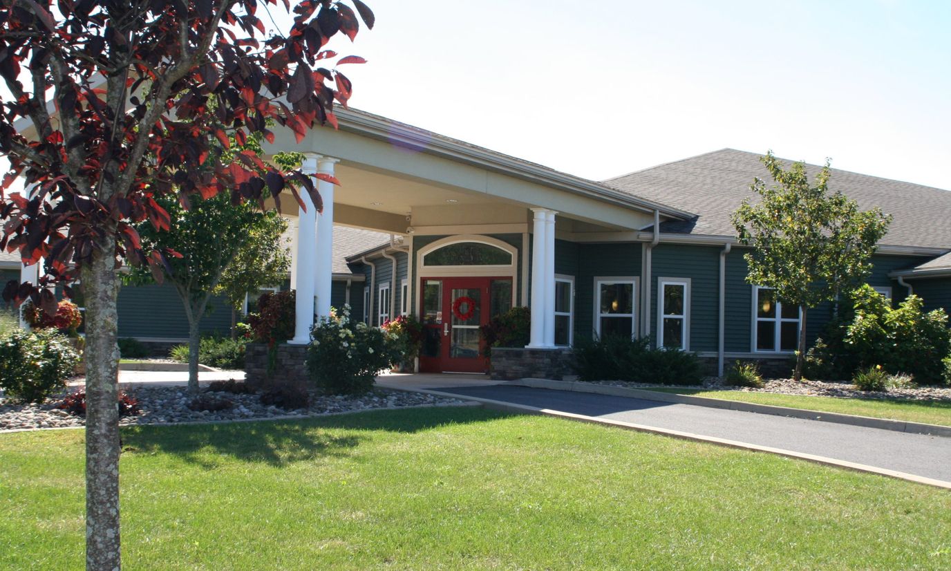 Main entrance of Wolf Run Village with landscaped surroundings