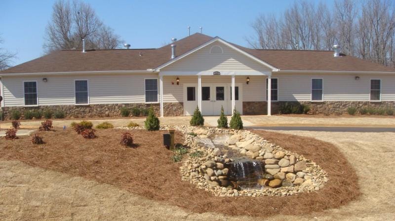 Exterior view of Reid House with garden features