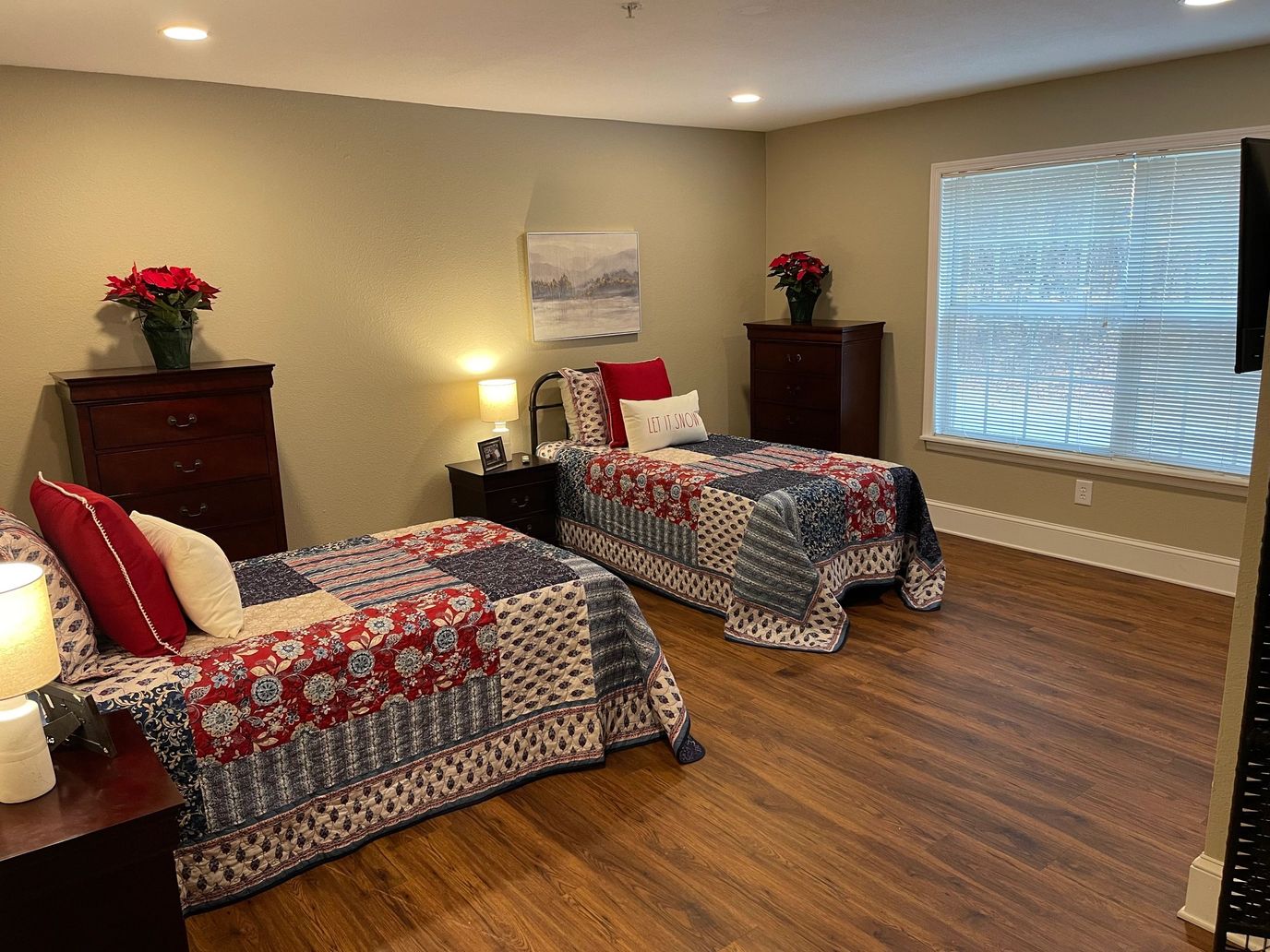 Comfortable resident room with two beds and window