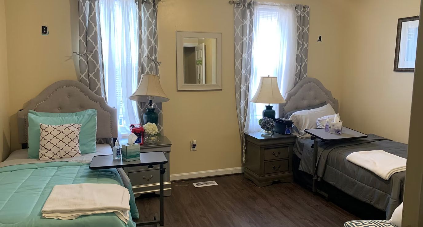 A shared resident room with two beds and natural light