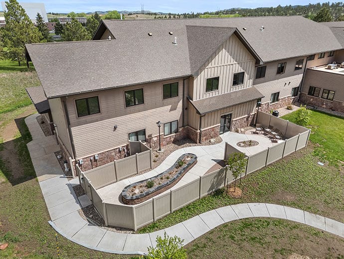 Exterior view of a senior living facility with landscaped garden