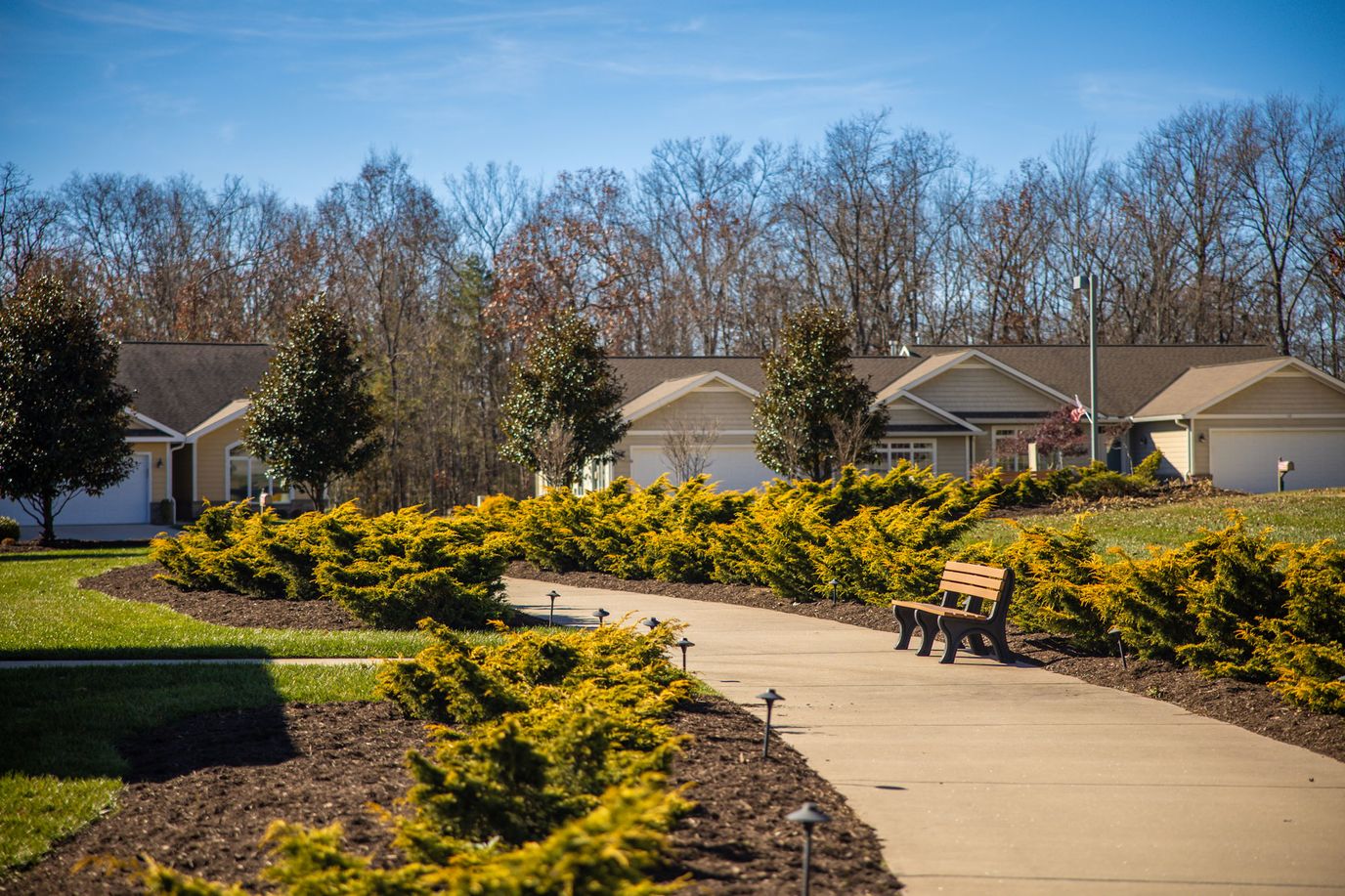 Pathway through landscaped garden at a senior living facility