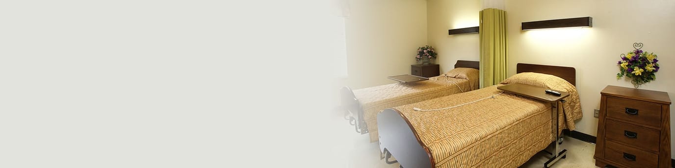 A shared resident room with two beds and decor