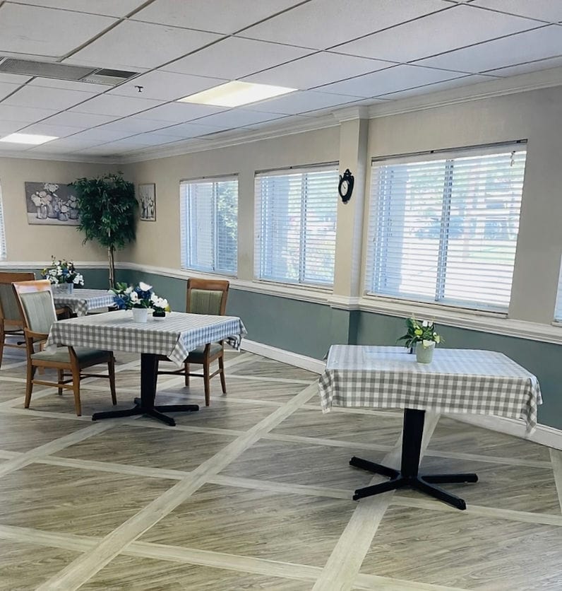 Dining area with checkered tablecloths and flowers