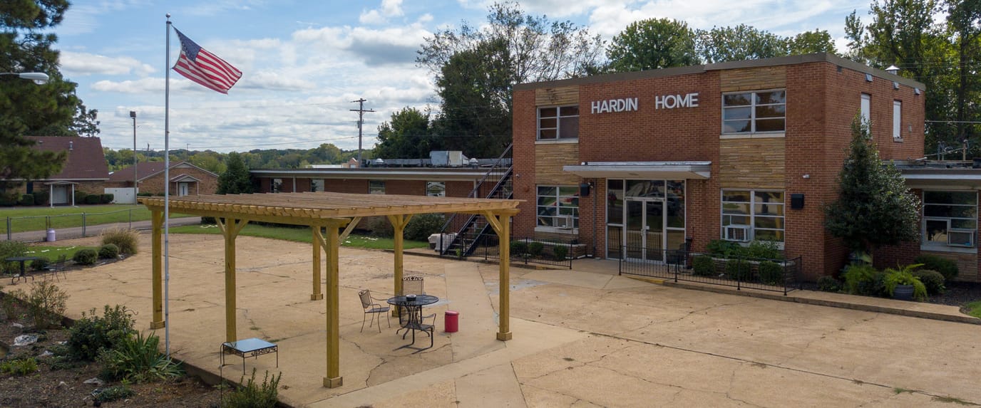 Exterior view of Hardin Home Nursing Home with patio area