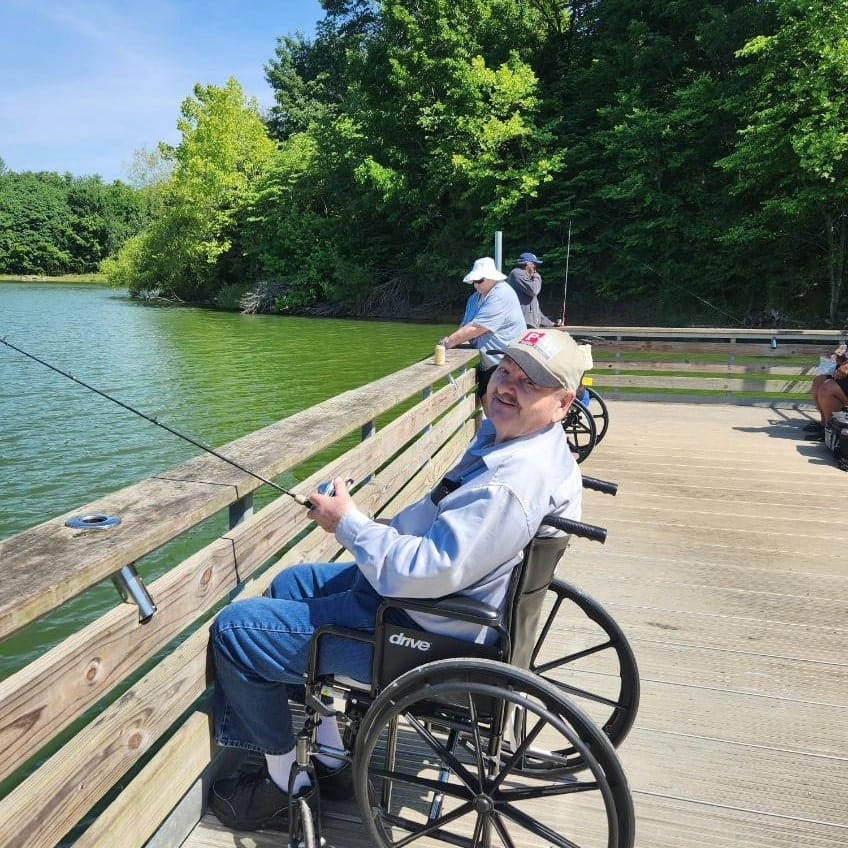 Residents fishing by the lake on a sunny day
