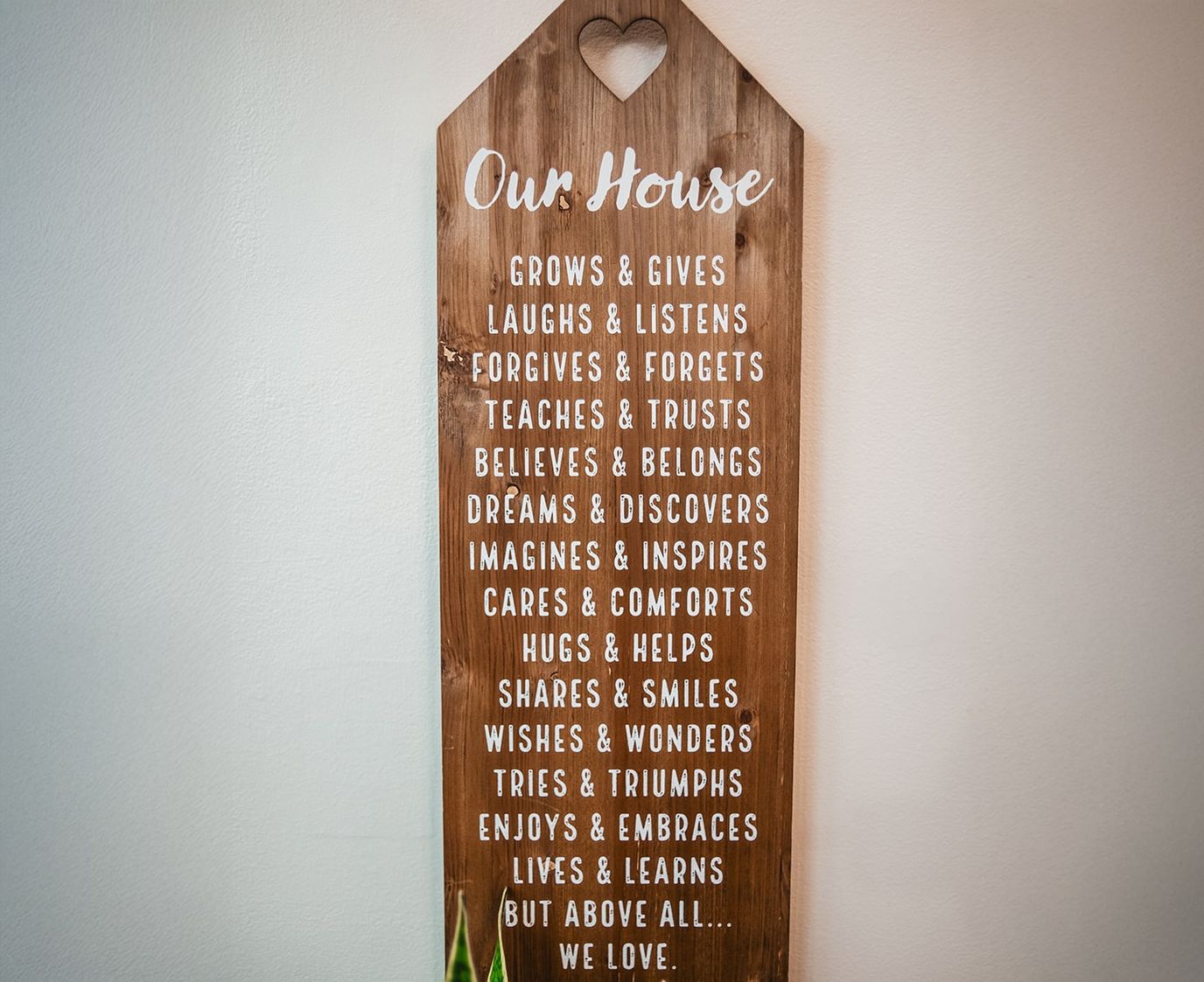Wooden sign with welcoming phrases