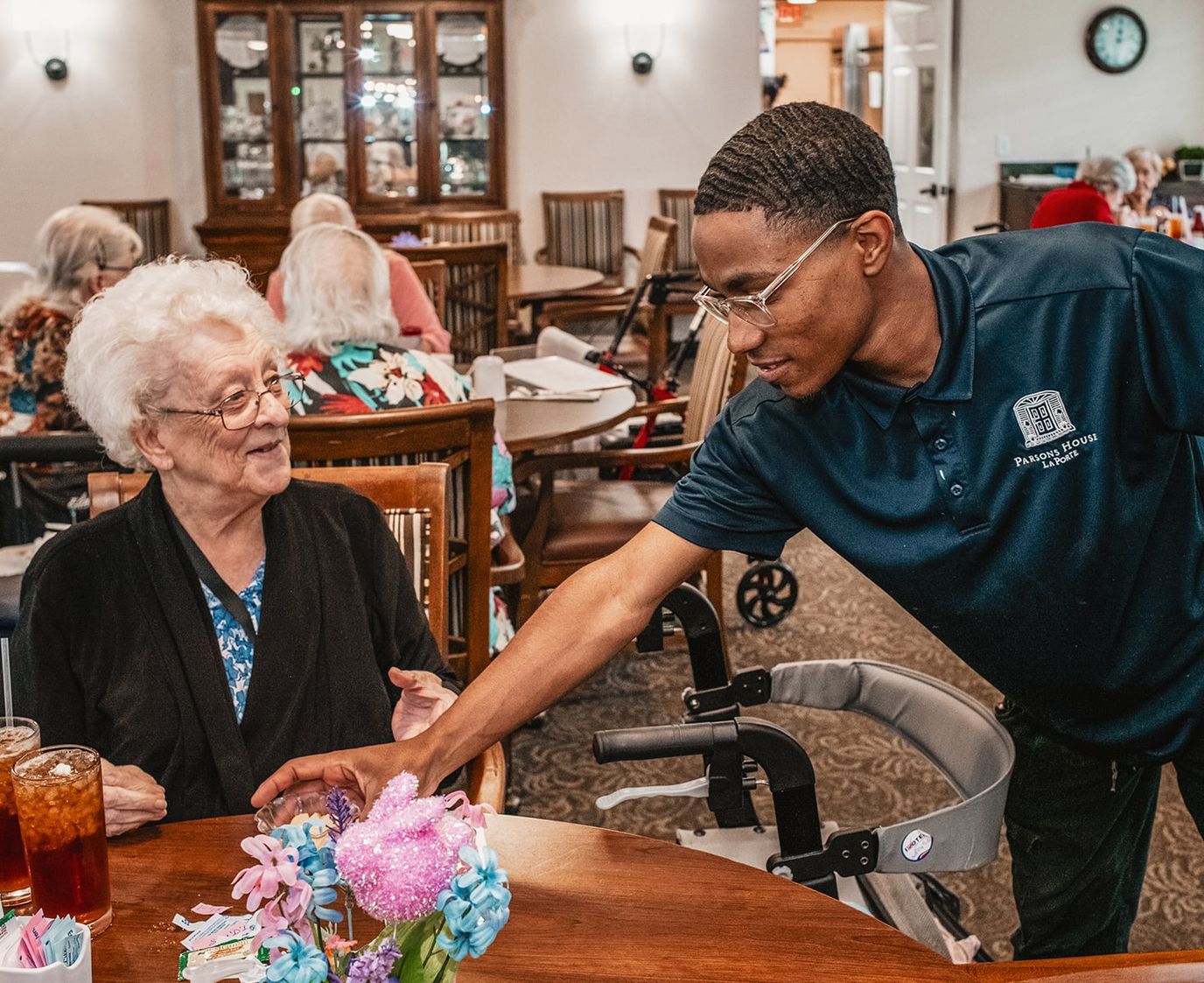 Staff assisting a resident in a common area