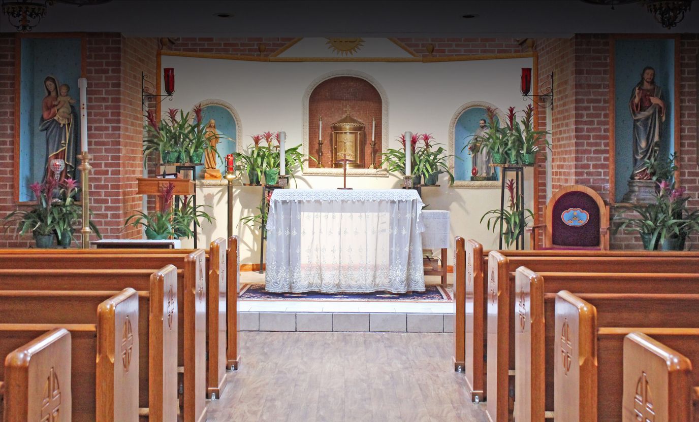 Interior view of a chapel with wooden pews and altar