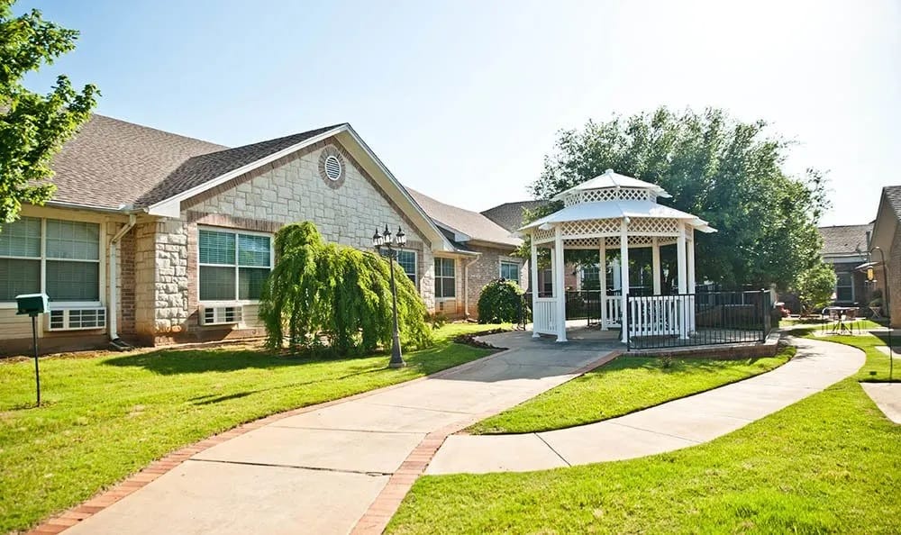 Exterior view of assisted living residence with courtyard and gazebo