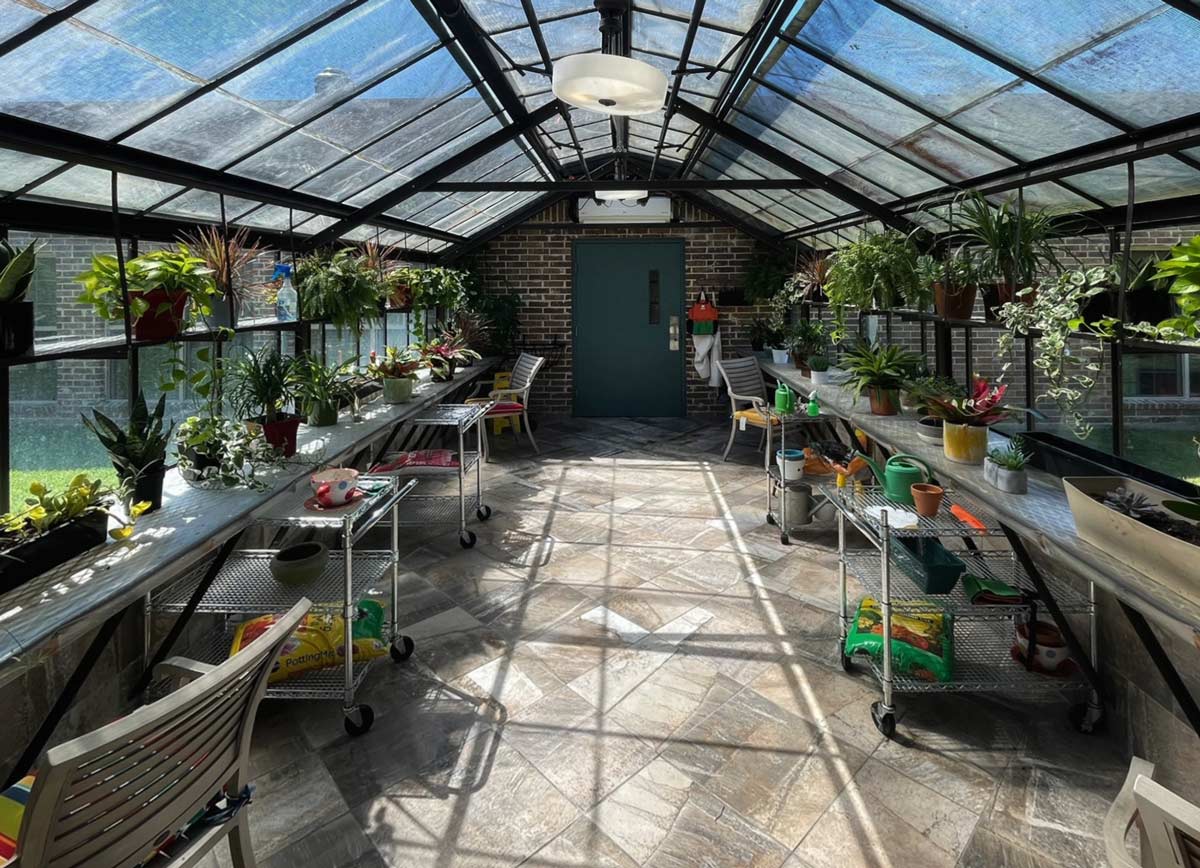 Greenhouse filled with plants and gardening supplies